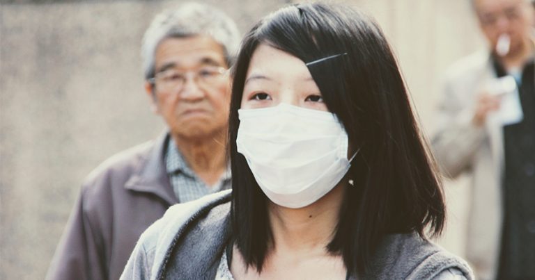 Woman wearing a flu mask