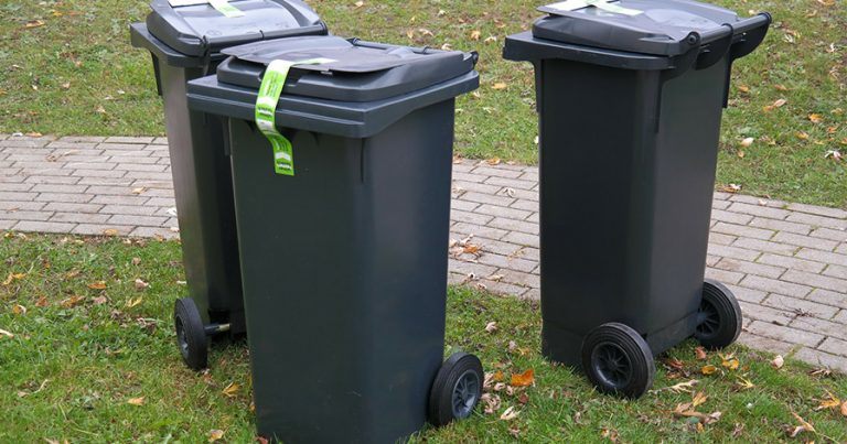 Three outdoor trash cans