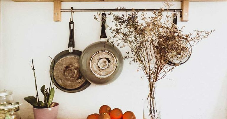 Pots hanging from rack in kitchen