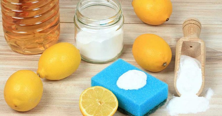 Green cleaning supplies, including lemons, baking soda, and vinegar.