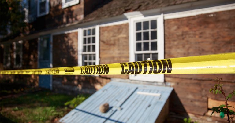Crime scene tape in front of a house