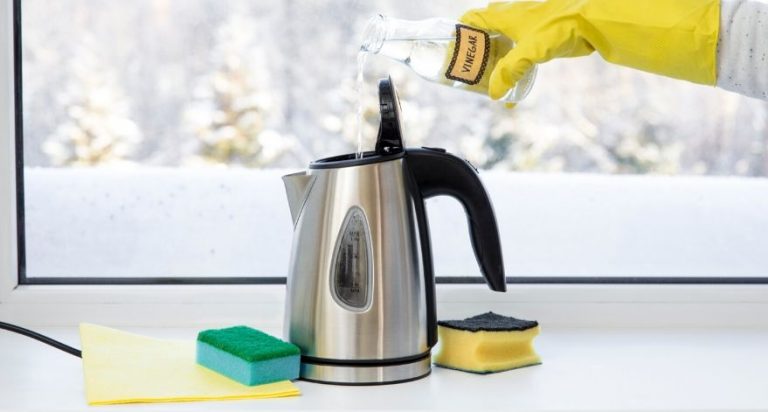 Someone pouring vinegar into their electric kettle to clean it.