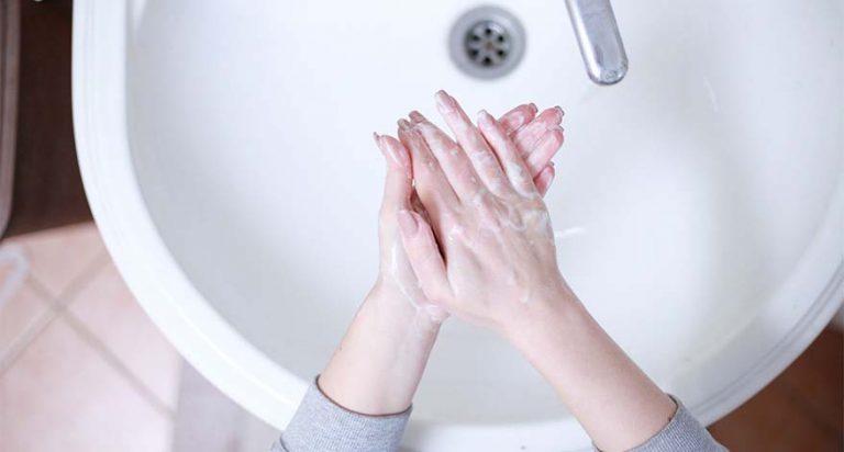 Soemone washing their hands.
